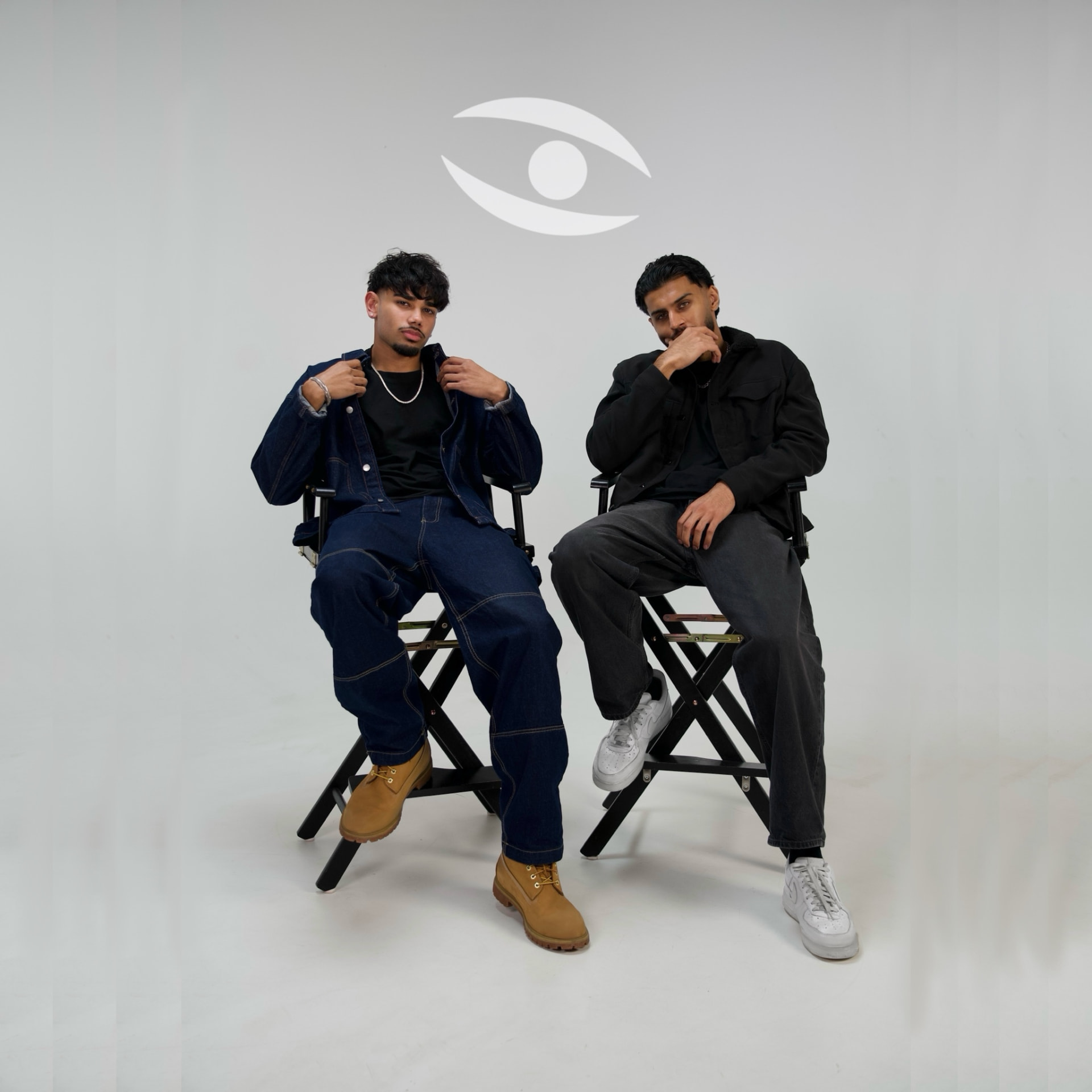 The two-person Stealth Media team seated on director's chairs