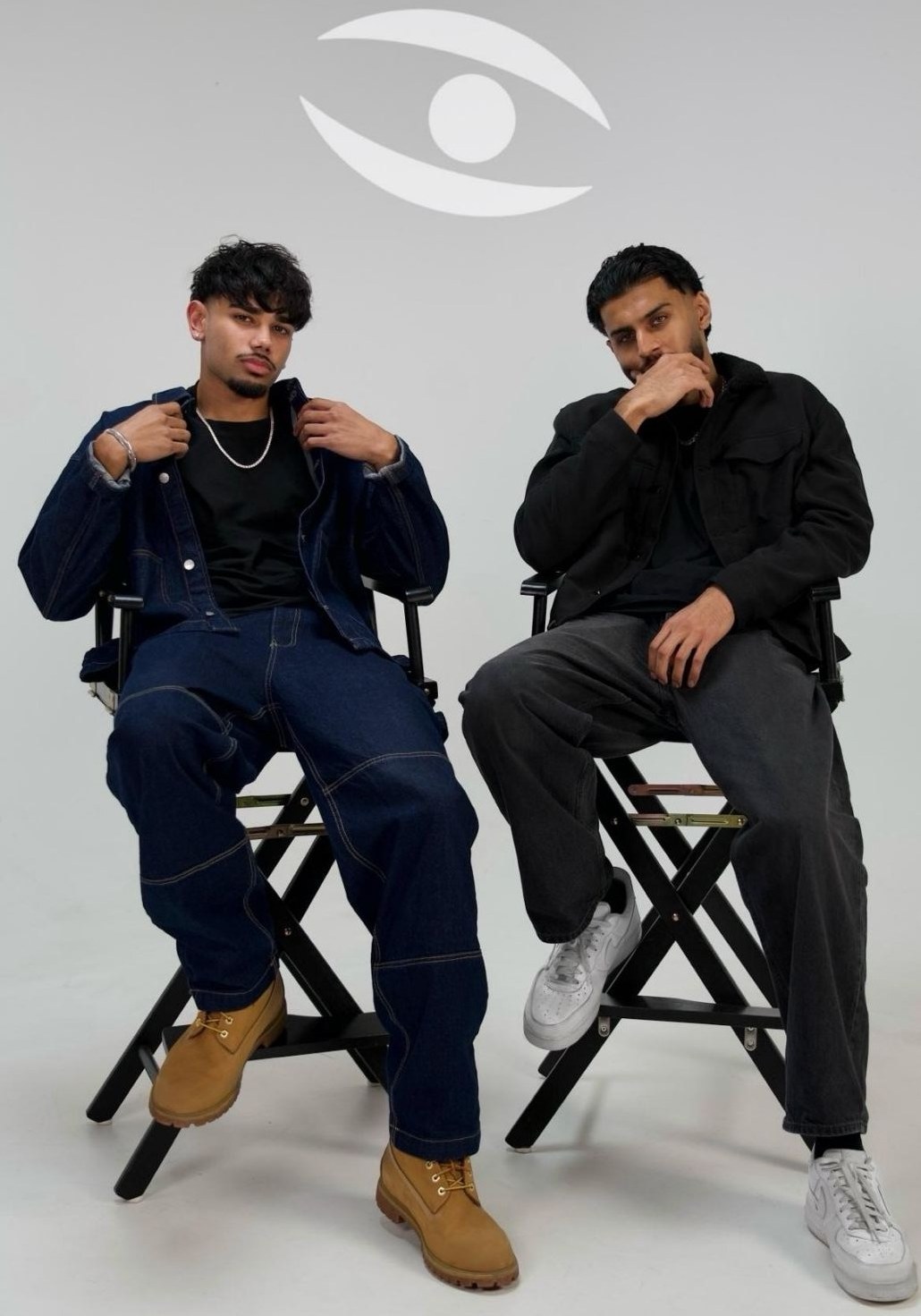 The two-person Stealth Media team seated on director's chairs